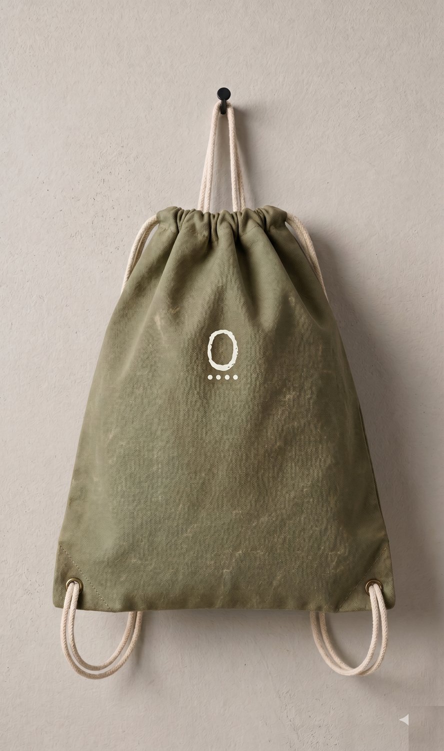TYP0stet waxed cotton canvas drawstring knapsack in olive, front 0 monogram in bone cream